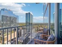 Stunning balcony view with seating, overlooking the city skyline and lush greenery at 860 Peachtree Ne St # 1903, Atlanta, GA 30308