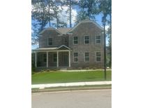 Charming two-story brick home featuring a covered front porch and manicured lawn at 495 Hancock Se Dr, Atlanta, GA 30354