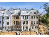 Three story townhome with white and brick exterior at 1788 Peach Blossom Ne Ln # 45, Atlanta, GA 30324