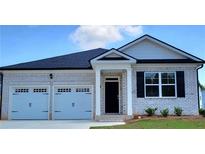 Charming, new construction home featuring a brick facade, a two-car garage, and a welcoming entryway at 130 Oakchase Park Ln, Hampton, GA 30228