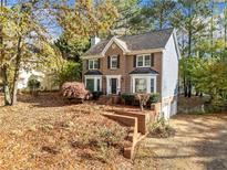 Two-story brick home with attached garage and landscaped yard at 401 Briardale Ct, Woodstock, GA 30189