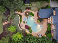 Stunning aerial view of a backyard oasis featuring a custom pool, spa, and lush landscaping at 1319 Glen Cedars Dr, Smyrna, GA 30126