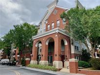 Brick building with arched entryway, landscaping, and ample parking at 1850 Cotillion Dr # 3221, Dunwoody, GA 30338
