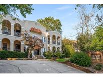 Charming multi-story condo with stucco walls, red tile roof accents, and lush landscaping at 856 Briarcliff Ne Rd # 5, Atlanta, GA 30306