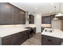 Modern kitchen boasts stainless steel appliances, white countertops, and dark wood cabinets at 348 Olmstead Way # 30, Alpharetta, GA 30022