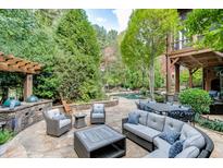 Spacious backyard patio with seating area, pergola, and built-in grill at 879 Big Horn Hollow, Suwanee, GA 30024