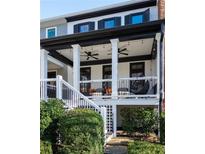 Two story home with front porch and landscaping at 703 Hammond Dr, Woodstock, GA 30188