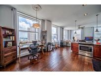 Spacious living room with hardwood floors, large windows, and an open floor plan to the kitchen at 57 Forsyth Nw St # 12B, Atlanta, GA 30303