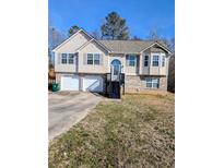 Charming two-story home featuring a two-car garage and a welcoming front entrance with stairs at 110 Lava Ct, Carrollton, GA 30116