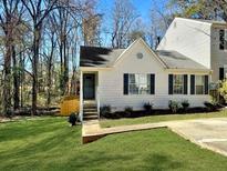 Charming home with white siding, black shutters, and a well-manicured front lawn at 2035 Marbut Trce, Lithonia, GA 30058