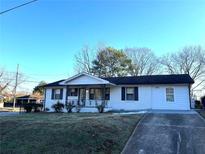 Charming single story home featuring a well manicured front yard and covered entryway at 1370 Georgia Ave, Atlanta, GA 30344