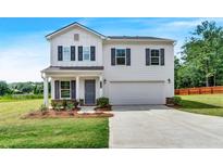 Charming two-story home featuring a covered porch, a two car garage and well-maintained landscaping at 3270 Forest Green Dr, Douglasville, GA 30135
