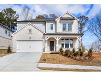 Two-story house with white brick exterior, gray siding, and a front porch at 1475 Auburn Glen Rd, Dacula, GA 30019