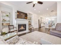 Bright living room showcasing a fireplace, dark wood floors, and open access to the kitchen at 2341 Brissett Ln, Brookhaven, GA 30319