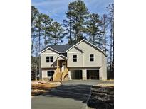 Two-story house with a large driveway and attached two-car garage at 724 Vinson Mountain Crossing Rd, Rockmart, GA 30153