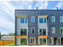 Modern townhome exterior with large windows, gray siding, and black accents at 1641 Mcnaught Dr # 35, Atlanta, GA 30317