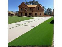 Two-story house under construction with a large driveway and artificial turf at 1452 Stephens View Dr, Loganville, GA 30052