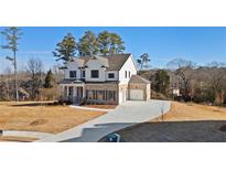Beautiful two-story home featuring a brick and white facade, well-manicured lawn, and a long driveway at 3816 Havenrock Drive, Marietta, GA 30066