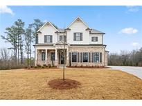 Beautiful two-story home featuring a brick and white siding exterior with a well-manicured lawn at 3816 Havenrock Drive, Marietta, GA 30066