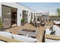 Inviting roof deck features an outdoor kitchen, dining and seating areas, and a modern fire pit at 318 Sandy Springs Cir # 310, Sandy Springs, GA 30328