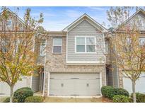 Charming townhome with brick and siding exterior, attached two-car garage and manicured landscaping at 4429 Newfangle Rd, Stone Mountain, GA 30083