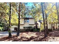 Two-story house with attached garage and deck, surrounded by trees at 1165 Plantation Dr, Villa Rica, GA 30180