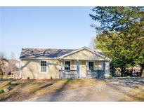Charming single-story home featuring a welcoming front porch and light yellow siding at 2502 Park Dr, Lithonia, GA 30058