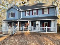 Two-story house with a wraparound porch and gray siding at 101 Emily Ln, Carrollton, GA 30116