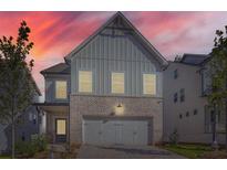 Charming home featuring gray siding, brick accents, and a two-car garage for a modern aesthetic at 640 Avondale Park Cir, Decatur, GA 30032
