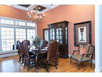 Elegant dining room with a dark wood table and leather chairs, illuminated by a decorative chandelier at 86 Waterford Path, Hiram, GA 30141