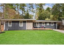 Charming ranch home with gray siding, stone accents, and a spacious lawn at 956 Cardova Dr, Atlanta, GA 30324
