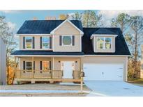 Two-story house with tan siding, dark roof, and a front porch at 6478 Beaver Creek Trl, Atlanta, GA 30349