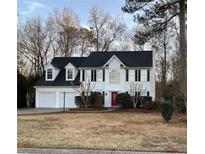 Two-story house with white siding, red door, and a two-car garage at 176 Crestworth Ct, Powder Springs, GA 30127