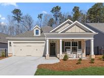 Charming single-story home with a two-car garage, inviting front porch, and manicured lawn at 1351 Cedarcrest Blvd, Acworth, GA 30101