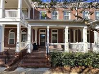 Brick townhouse with front porch and white columns at 617 Brennan Dr, Decatur, GA 30033