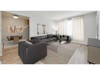 Bright living room with modern furnishings, hardwood floors, and an adjacent dining area at 1284 Piedmont Ne Ave # 5, Atlanta, GA 30309