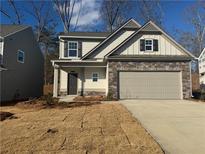 Two-story house with stone accents and a two-car garage at 372 Bloomfield Cir, Canton, GA 30114