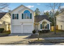 Two-story house with a two-car garage and landscaped yard at 2722 S Hills, Riverdale, GA 30296