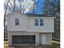 Two-story house with vinyl siding and brick accents, featuring a one-car garage at 129 Creek Crossing Ln, Temple, GA 30179