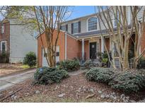Charming two-story home with brick accents, a one-car garage, and mature landscaping in a neighborhood setting at 3187 Kingswood Gln, Decatur, GA 30034