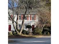 Two-story townhome with red shutters and landscaping at 3980 Bayside Cir, Atlanta, GA 30340