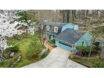 Inviting blue two-story home with a well-manicured lawn and a quaint two-car garage at 2548 Mercedes Ne Dr, Atlanta, GA 30345