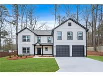 Two-story house with white siding, black accents, and a two-car garage at 4352 Riverlake Way, Snellville, GA 30039