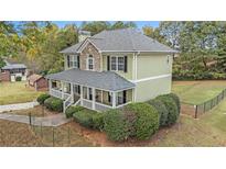Two-story house with stone accents, front porch, and landscaped yard at 815 Sylvan Dr, Marietta, GA 30066