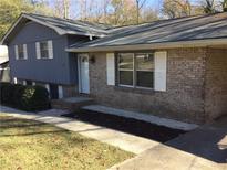 Charming single-Gathering home featuring a brick facade and inviting front entrance at 2787 Heritage Ln, Morrow, GA 30260