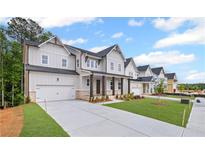 Charming two-story home with a gray facade, covered porch, and well-manicured lawn in a new neighborhood at 729 Keystone Dr, Woodstock, GA 30188