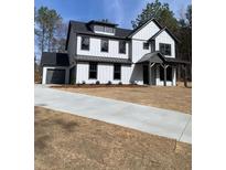 Two-story home featuring white vertical siding, a covered porch, and a dark gray roof at 3745 Pilgrim Mill Rd, Cumming, GA 30041