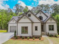 Charming two-story home with white siding, grey trim, and a landscaped yard at 3780 Tamiami Trl, Cumming, GA 30041
