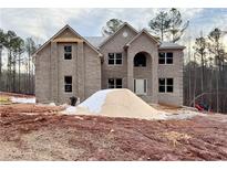 Two-story brick house with a large front yard under construction at 5390 Deer Run Dr, Conyers, GA 30094