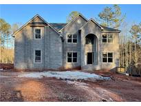 Stately two-story home featuring a gray brick facade and multiple windows for ample natural light at 5390 Deer Run Dr, Conyers, GA 30094